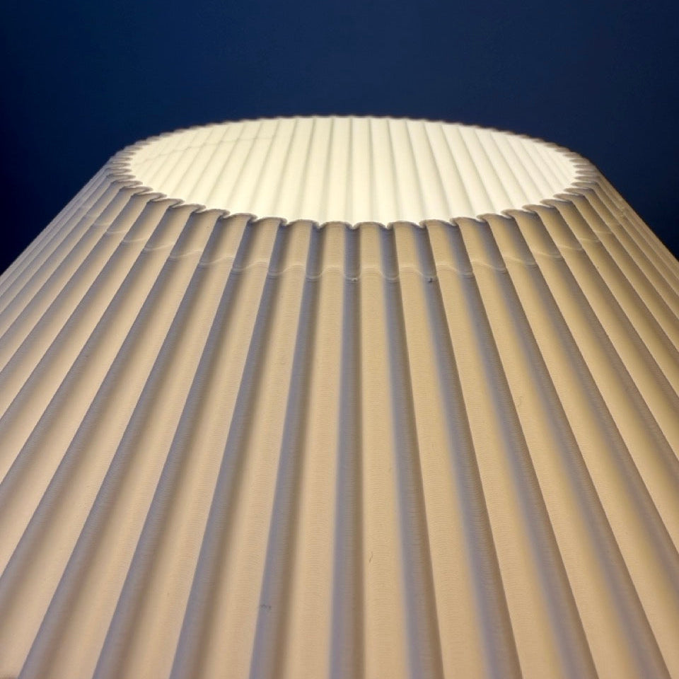 Close-up of a pleated fabric texture against a dark background