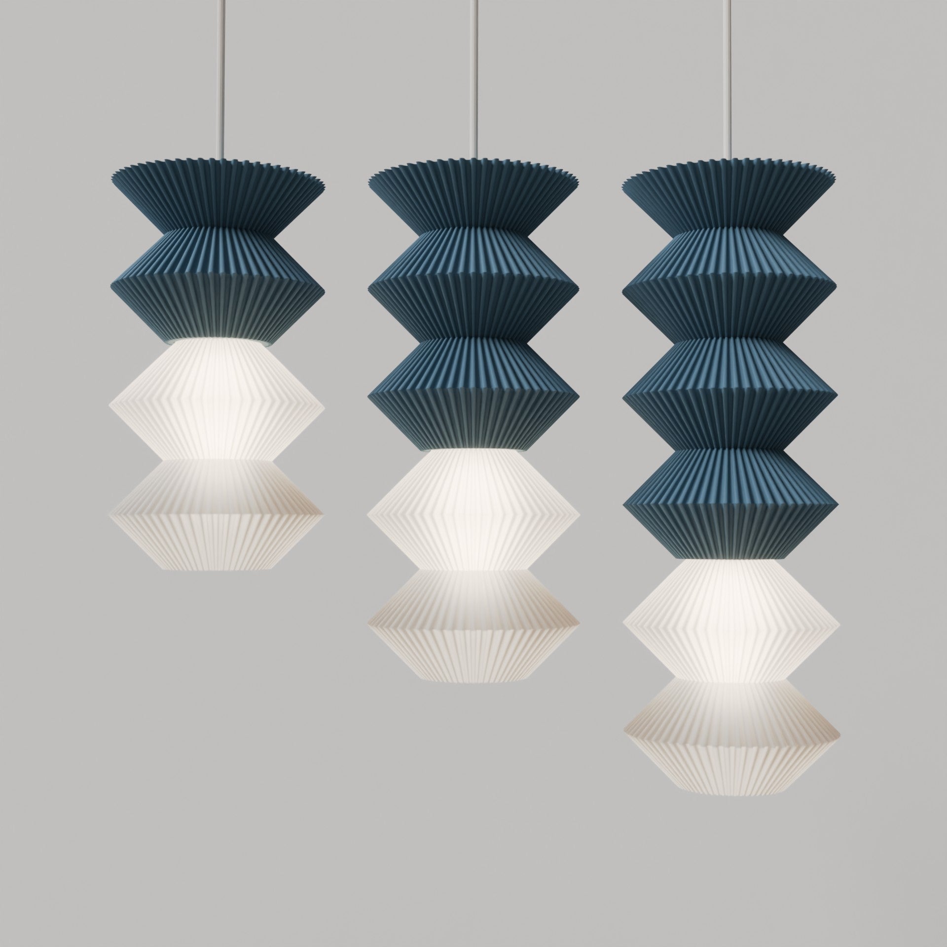 Set of three pendant lights with blue and white designs on a gray background